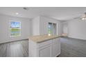 Kitchen featuring an island, wood-look flooring, and a view of the water at 639 Gila Dr, Poinciana, FL 34759