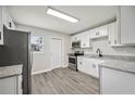 Bright kitchen with white cabinets, stainless steel appliances, and modern countertops at 1037 Waynesville Ave, Lakeland, FL 33801