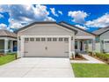 Charming single-story home with a two-car garage, covered entry and well manicured lawn at 3817 Corsican Pl, Lake Alfred, FL 33850
