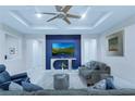 Sophisticated living room featuring a blue accent wall, modern lighting, and comfortable seating at 7071 Spring Park Dr, Winter Garden, FL 34787
