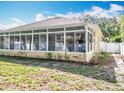 Enclosed sunroom with white framed windows, offering plenty of natural light and outdoor views at 2376 Home Again Rd, Apopka, FL 32712