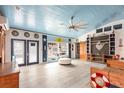 Open-concept living area with blue-painted ceiling, nautical decor, and ample natural light at 370 Hartford Ave, Daytona Beach, FL 32118