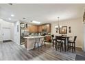 Inviting kitchen featuring an island with seating, stainless steel appliances and tile backsplash at 6109 Apollos Corner Way, Orlando, FL 32829
