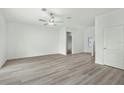 Bright and spacious living room featuring wood-look floors and ample natural light at 13275 Tula Loop, Astatula, FL 34705