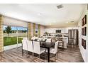 Dining area with sliding glass doors to backyard and an open view to the kitchen with stainless steel appliances at 1030 Foreshore Ln, Haines City, FL 33844