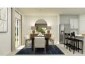 Bright dining area with a modern table, chairs, stylish lighting, and stainless steel refrigerator at 1313 Acorn Meadow Loop, Eustis, FL 32726