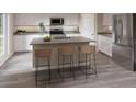 Modern kitchen with stainless steel appliances, center island with seating, and sleek gray countertops at 3766 King Hill Dr, Haines City, FL 33844