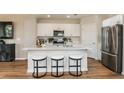 Stylish kitchen featuring an island with seating, stainless steel appliances, and ample cabinet space at 3799 King Hill Dr, Haines City, FL 33844