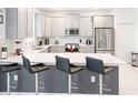 Modern kitchen featuring stainless steel appliances, a breakfast bar, and ample cabinet space at 4149 Paragraph Dr, Kissimmee, FL 34746