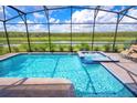 Enjoy this screened-in pool and spa with a scenic water view in a private backyard oasis at 4149 Paragraph Dr, Kissimmee, FL 34746