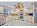 Spacious kitchen featuring ample cabinetry, stainless steel appliances, and a unique ceiling fan at 6589 Banyan Dr, Indian Lake Estates, FL 33855
