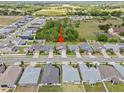 Drone shot showing the house location in a suburban neighborhood near a field at 5008 Ne 125Th Loop, Oxford, FL 34484