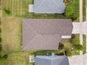 Overhead aerial view of the roof, backyard, and well-maintained landscaping at 5008 Ne 125Th Loop, Oxford, FL 34484