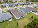 Aerial view of the backyard with a well-maintained lawn and neighboring homes at 5008 Ne 125Th Loop, Oxford, FL 34484