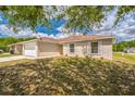 Single-story home with a two-car garage and a neatly landscaped front yard at 1628 Saddlehorn Dr, Lakeland, FL 33810