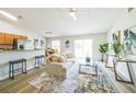 Bright living room with modern decor, wood floors, and an open layout to the kitchen at 1628 Saddlehorn Dr, Lakeland, FL 33810