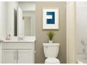 Bright bathroom with white vanity, modern fixtures, and a decorative art print at 947 Hour Glass Rd, Lakeland, FL 33801