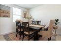 Elegant dining room featuring a dark wood table and plush seating, bathed in natural light at 2674 San Marco Way, Winter Haven, FL 33884