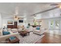 Bright, staged living room with brick fireplace, white walls, and wood floors at 430 Alturas Babson Park Cutoff, Lake Wales, FL 33859