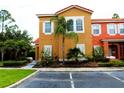Charming two-story townhome with lush landscaping and a vibrant facade at 151 Pompano Beach Dr, Kissimmee, FL 34746