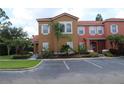 Attractive townhome features lush landscaping and a red tile roof at 151 Pompano Beach Dr, Kissimmee, FL 34746