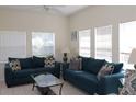 Bright living room featuring neutral walls, tile flooring, and comfortable seating with plenty of natural light at 151 Pompano Beach Dr, Kissimmee, FL 34746