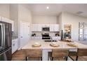 Bright kitchen featuring white cabinets, stainless steel appliances, and a central island with seating at 1034 Foreshore Ln, Haines City, FL 33844