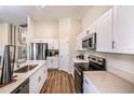 Bright open kitchen with white cabinets, stainless steel appliances and stone countertops at 1034 Foreshore Ln, Haines City, FL 33844