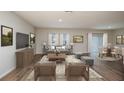 Spacious living room with wood flooring, neutral paint, recessed lighting and a sliding glass door to the exterior at 4047 Gardenia Ave, Lake Hamilton, FL 33851