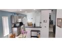 Bright eat-in kitchen with stainless steel appliances, tile flooring, and lots of cabinets at 210 Cheshire Way, Davenport, FL 33897