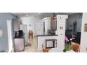 Bright eat-in kitchen with stainless steel appliances, tile flooring, and lots of cabinets at 210 Cheshire Way, Davenport, FL 33897