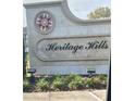 The stone sign for Heritage Hills in a manicured garden at the community entrance at 3205 Sonesta Ct # B, Clermont, FL 34711