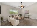 Cozy living room with neutral paint, a ceiling fan, lots of natural light and stylish decor at 100 Essex Dr, Longwood, FL 32779