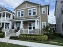 Lovely two-story home with a charming front porch and well-maintained landscaping at 7418 Barrier Cove Way, Celebration, FL 34747