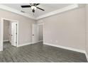 Spacious bedroom featuring a ceiling fan, with a closet and ensuite bathroom access, providing comfort and convenience at 7756 Somersworth Dr, Kissimmee, FL 34747