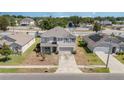 This aerial view shows a well-maintained home in a quiet suburban neighborhood with green lawns and mature trees at 5597 Forest Ridge Dr, Winter Haven, FL 33881