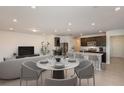 An open floor plan living space with a modern kitchen featuring an island and dark wood cabinetry at 9072 Wildlight Trl, Wildwood, FL 34785