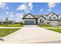 Charming single-story home with a well-manicured lawn and a gray garage door at 16998 Cedar Valley Cir, Clermont, FL 34711