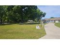 Expansive front yard with mature trees and the home in the background at 6975 Sw 99Th St, Ocala, FL 34476