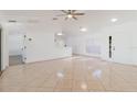 Spacious living room with tile floors, ceiling fan, and ample natural light at 1472 Muir Cir, Clermont, FL 34711