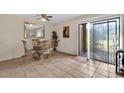A formal dining room features a glass-top table, four ornate chairs, and sliding glass doors at 337 Scottsdale Sq # 337, Winter Park, FL 32792