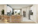 Open kitchen boasts a breakfast bar and stainless steel refrigerator at 2095 Rider Rain Ln, Apopka, FL 32703