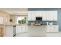 Modern kitchen featuring white cabinets and stainless steel appliances at 2095 Rider Rain Ln, Apopka, FL 32703
