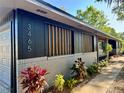 Close up of the house's exterior with the house number, stylish facade, and colorful plants at 3465 Peacock Ln, Mulberry, FL 33860