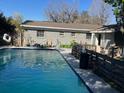 Large backyard pool with a fenced-in area and patio furniture at 4707 Melody Ln, Lakeland, FL 33805