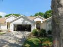 Charming single-story home with attached garage and lush landscaping, creating inviting curb appeal at 1184 Athlone Way, Ormond Beach, FL 32174