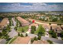 Aerial view of a residential community highlighting the home's location and proximity to the community pool at 1401 Wexford Way, Davenport, FL 33896