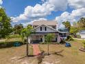 Charming two-story home with a welcoming front porch and a brick pathway leading to the entrance at 4145 Willis Rd, Mulberry, FL 33860