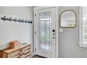 Welcoming entryway featuring a decorative mirror, wood cabinet and a stylish door with glass panel at 5811 Lake Breeze Ave, Lakeland, FL 33809