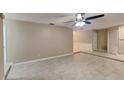 Spacious living room featuring neutral paint, tiled flooring, a ceiling fan, and access to other parts of the home at 699 Sullivan St, Deltona, FL 32725